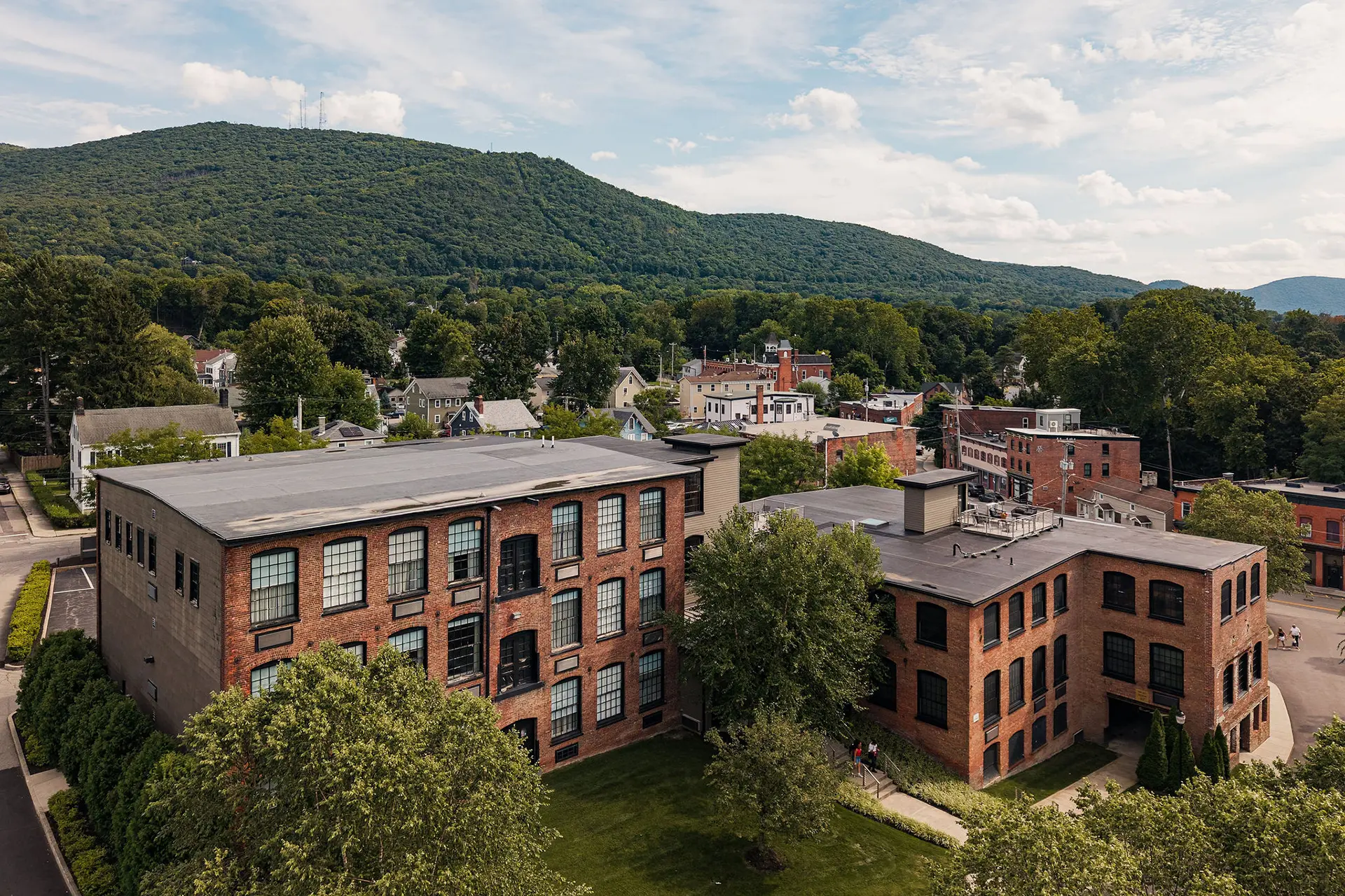 The roundhouse's mill building: a historic brick boutique hotel surrounded by greenery and mountains in the hudson valley